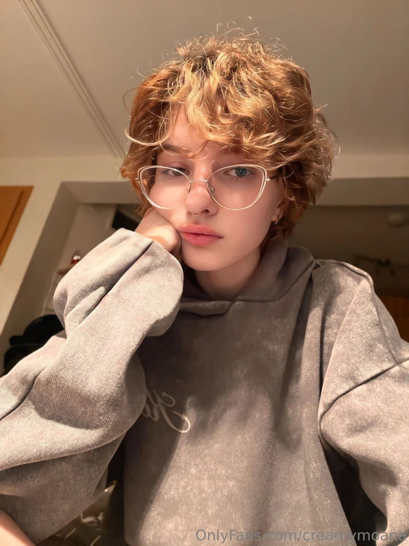 Evening vibes short curls glasses and a touch of a thoughtful mood 