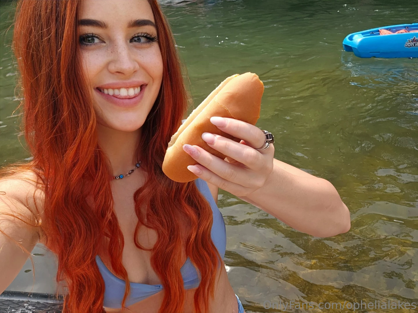 Enjoying a hotdog on the river i was paddleboarding and when i rounded 