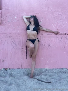 Black swimsuit pink wall and the ocean how do you like this look part 1