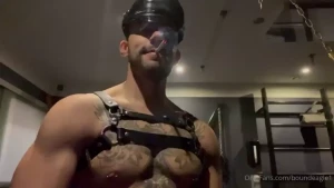 Smoking in tight leather gloves and leather gear and flexing big