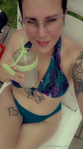 A pool and a drink almost a perfect day