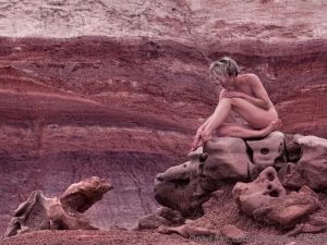 Naked in some cool colorful rocks photo by nimblephotons
