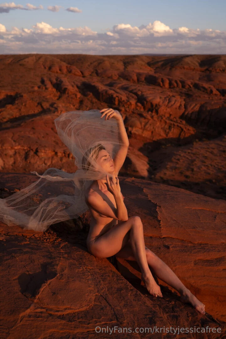 Pretty and sheer fabric and soft supple skin against blazing red rocks 