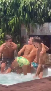 Watch two boys in a jacuzzi splashing water on the third guy s ass