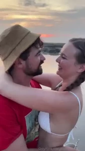 Being cute and kissing on the beach at sunset it s our last day in