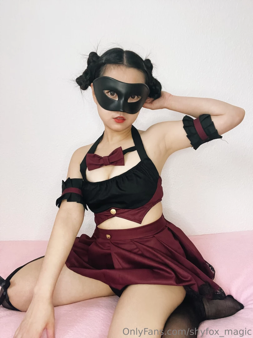 The rich deep tones of the burgundy skirt cascade with a soft 