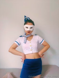 The chic cropped white top with gold buttons and matching blue mini