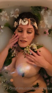 Elvish fae enjoying the sensual feeling of taking a candlelight bath