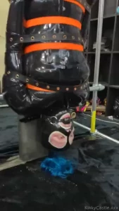 Lifting up a gagged rubberdoll into position part 2 of 9