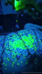 Slow motion uv wax play on a helplessly chained down sub