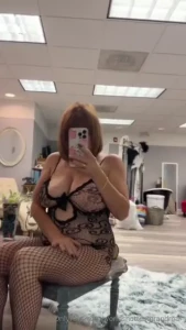 Looking into the mirror touching up her makeup thoughts of the evening