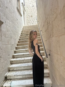 When a woman puts on a floor-length black dress she instantly