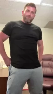 Pulling my hard dick out of gray sweatpants and jerking off at work