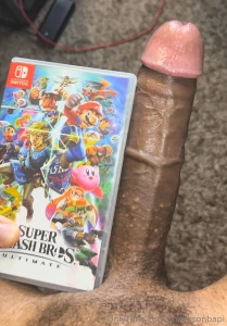 My dick next to a nintendo switch game case and a shroom bar box super part 3