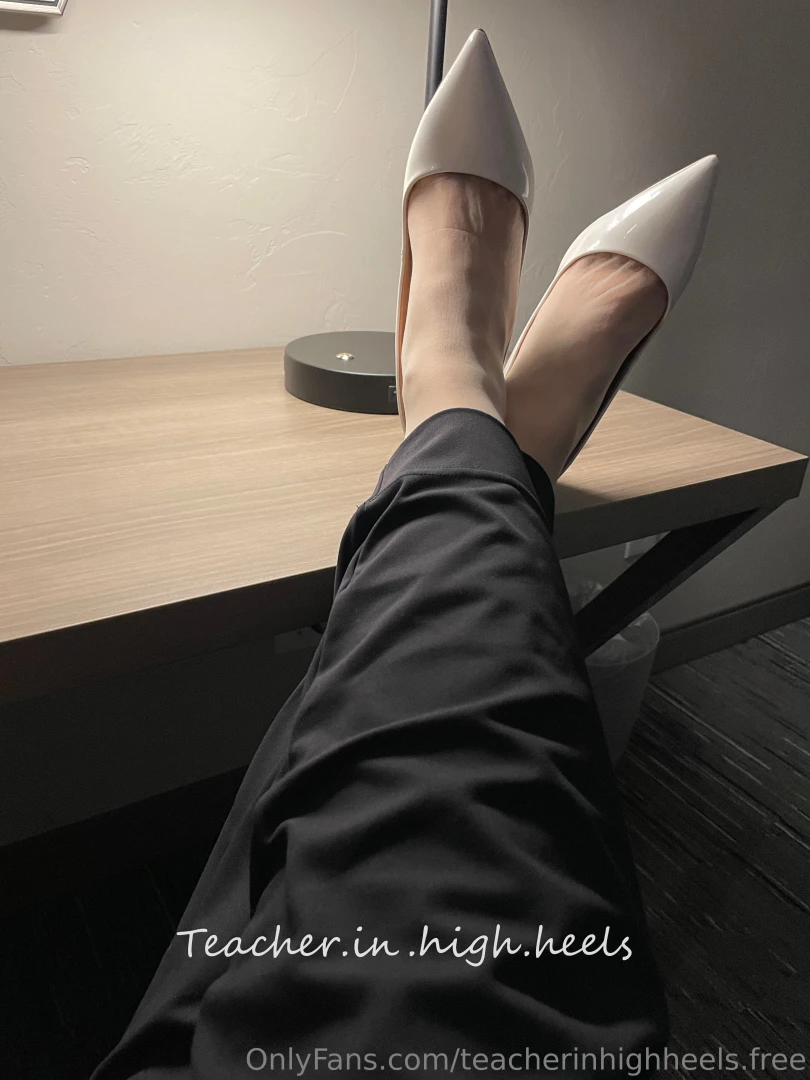 White tights and heels under black trousers 