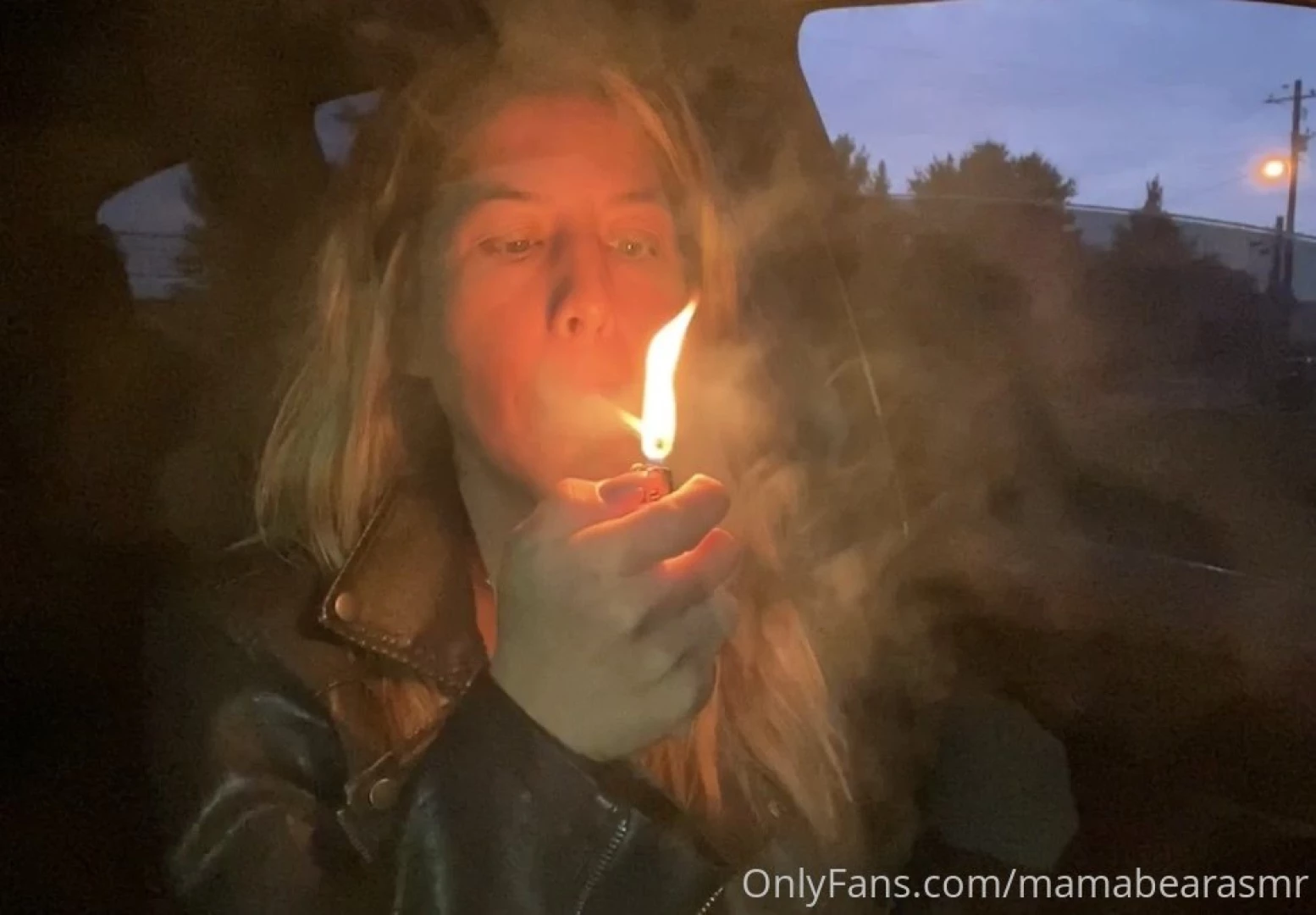 Smoking in leather jacket at night 