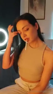 Smoking a marlboro red 100 in a sporty outfit and soft warm light