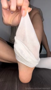 I slowly take off my white sneaker socks for you