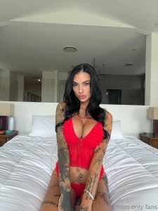 Wrapped in red on the bed and teasing you just right a little squeeze