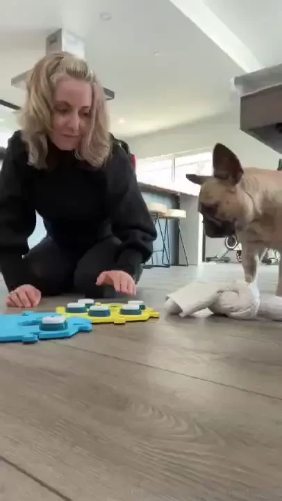 I m teaching mila how to communicate using buttons the teacher in our 