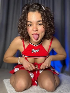 I strike a playful pose my cheerleader skirt swishing around my thighs