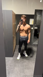 Shirtless in just leggings standing in front of the mirror like the