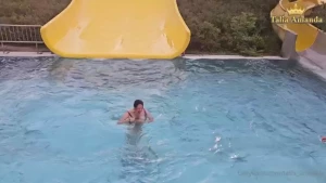 Hello watch how i go down fast from the slide in the swimming pool