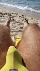 On the beach in a yellow thong wiggling my sandy bare feet that s