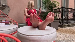 Crossed soles adorned with toe rings and anklets a princess in a red