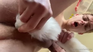Stripping nude in my window with my butt plug tail in feet pic