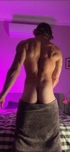 Towel slipping lower with every step just enough to reveal the curve