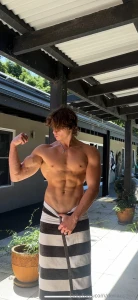 Outside the house abs tight biceps flexed and just a towel hiding this