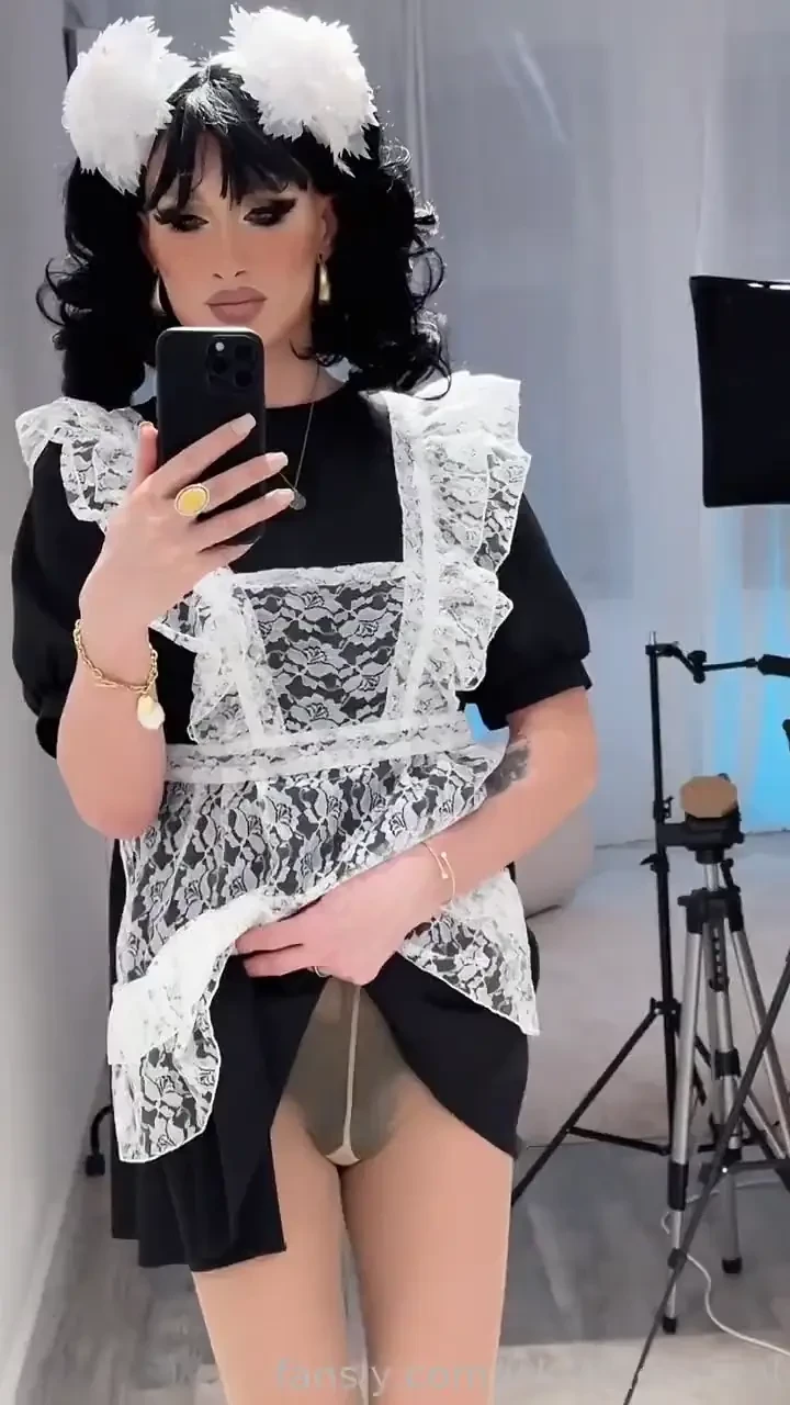 Sexy schoolgirl takes off her dress and poses in front of the mirror 