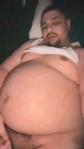 Fat pig rolling around starting to struggle to reach his own cock