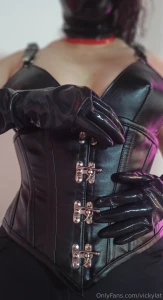 Opaque corset and harness bustier along with latex gloves see the