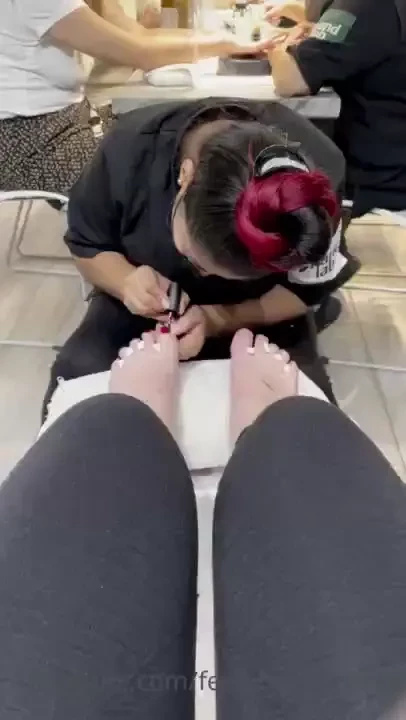 Had my pedi done yesterday here s the lady painting my toes red check 