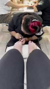 Had my pedi done yesterday here s the lady painting my toes red check