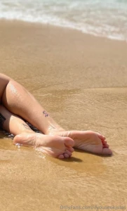 On vacation at the beach my beautiful feet touching the sand and