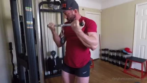 Home workout with flexing between sets in posing briefs