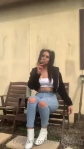 Smoking in skinny jeans and white boots with cigarette crush at the