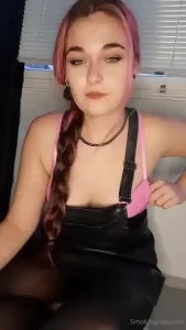 Smoking in a leather skirt and a bra