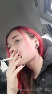 Close up vid in a car blowing smoke into the camera