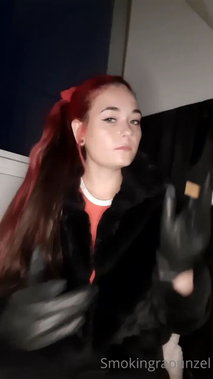 Smoking in a fur jacket and some leather gloves 