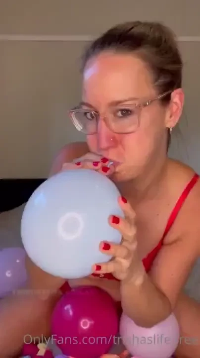 Playing with in red lingerie blowing them up squeezing them letting 