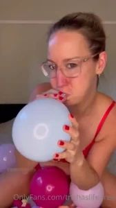 Playing with in red lingerie blowing them up squeezing them letting