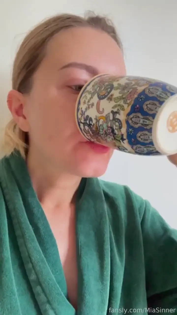 Evening piss play prep wrapped in my green robe i drink from a cup of 