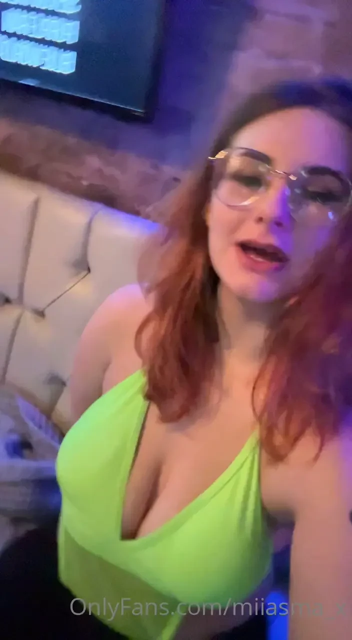 Driving topless in a car giving a good show to everyone passing 