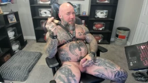 Jerking off while smoking a cigar in leather with a massive cum shot