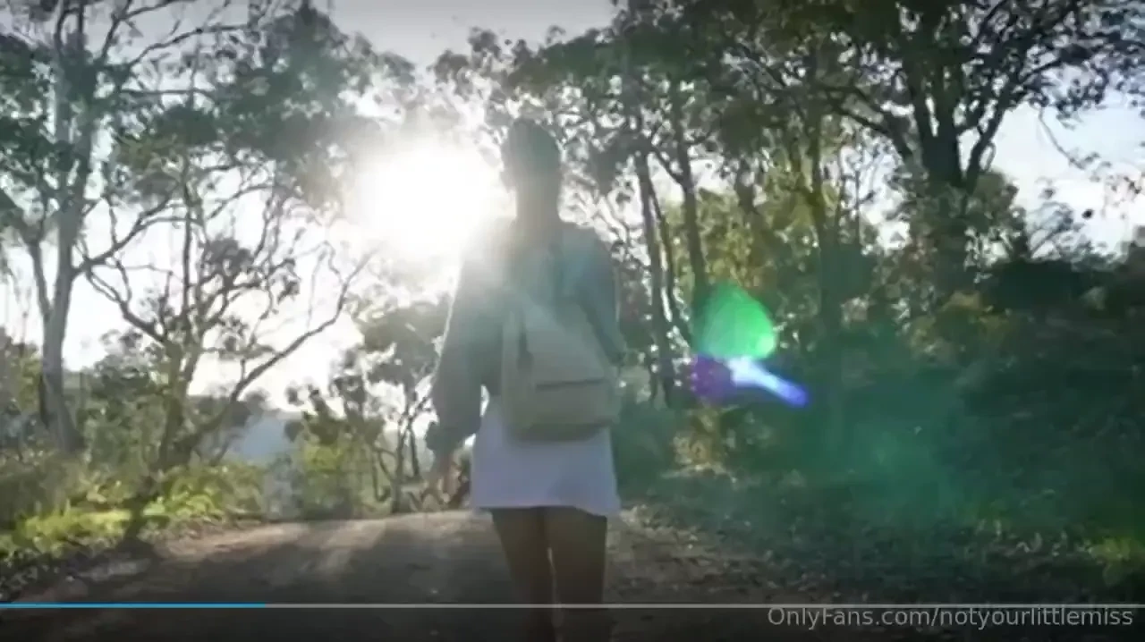 An innocent girl taking a nice stroll in the forest on a sunny day 