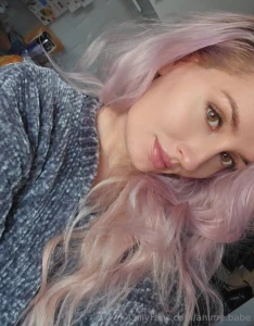 A girl with pink hair a curious sight her photo shines in the softest